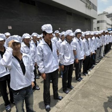 Foxconn workers outside a plant in Shenzhen in southern China’s Guangdong province before their shift. Photo: AFP