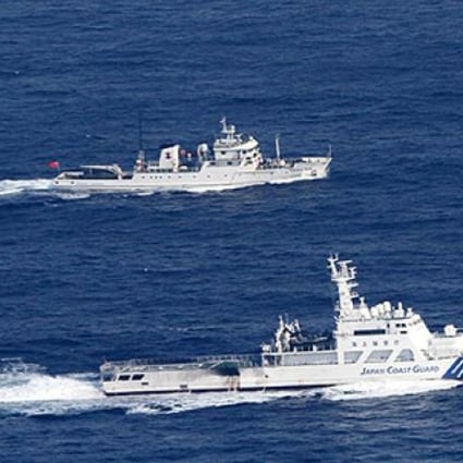 The Japanese coastguard (bottom) and a Chinese fisheries patrol boat sail near the disputed islands in the East China Sea last week. Photo: AP