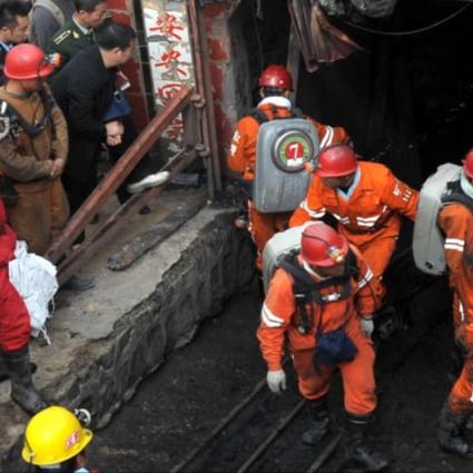 Rescuers leave the mine in Baiyin where two rail carriages carrying 34 miners ran out of control after a cable snapped. Photo: Xinhua