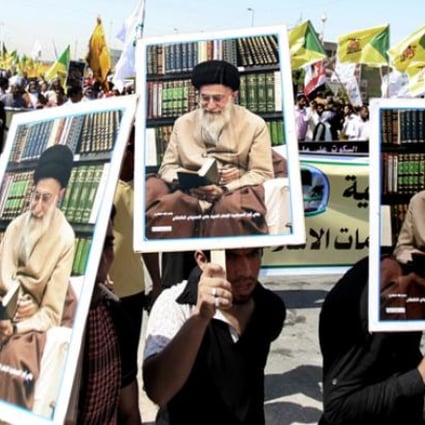 Iraqis chant slogans as they hold posters of Iran's supreme leader Ayatollah Khamenei during a protest in Basra on Friday. Photo: AP