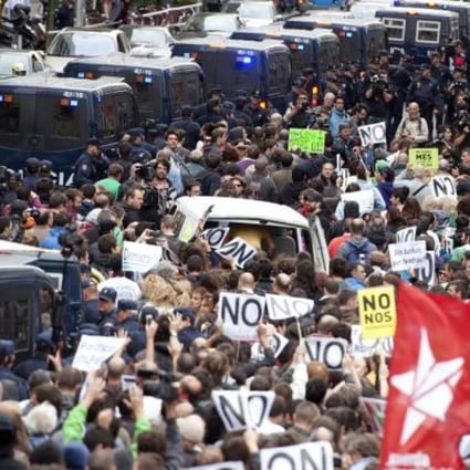 Demonstrators take part in a protest against the government's austerity measures, in front of the Parliament in Madrid.