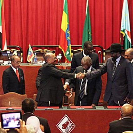 Sudan's President Omar al-Bashir (centre-left), and South Sudan's President Salva Kiir (centre-right) shake hands at the conclusion of the Sudan and South Sudan negotiations on post-secession matters in Addis Ababa on Thursday. Photo: AFP