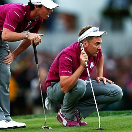 Rory McIlroy and Ian Poulter of Europe line up a putt on the 18th green at Medinah Country Club in Chicago, Illinois, on Saturday. Photo: AFP