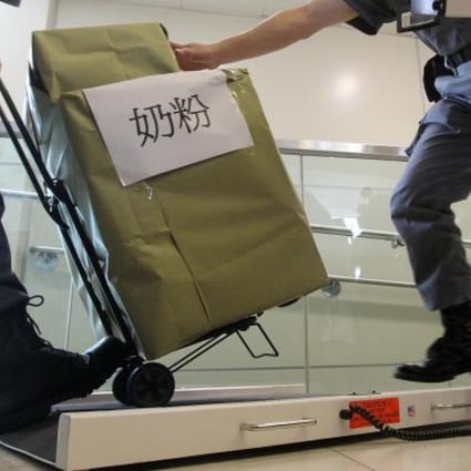 MTR staff demonstrate the digital scale they will be using to weigh passengers' luggage at border stations. Photo: K.Y.Cheng