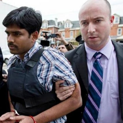 Raghunandan Yandamuri is led into court in a bullet-proof vest.