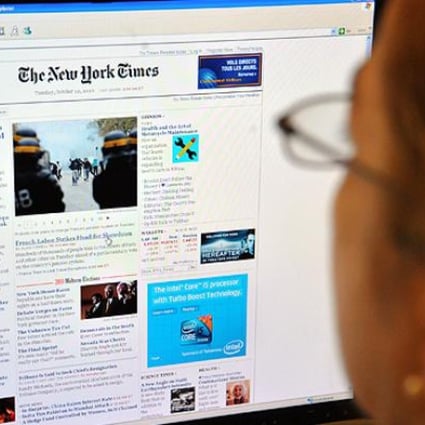 A woman reads The New York Times online. China blocked access to NYT websites after it reported Wen Jiabao's family had amassed vast riches. Photo: AFP