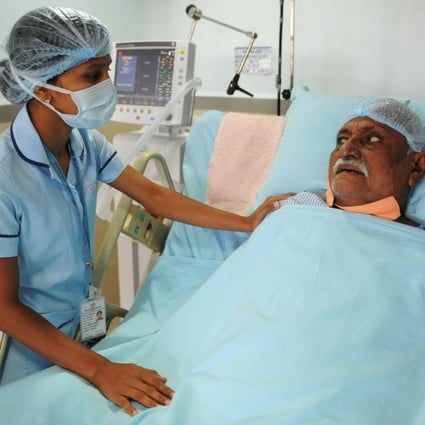 A nurse attends to a patient in the ICU ward at a hospital in Ahmedabad, India.Photo: AFP