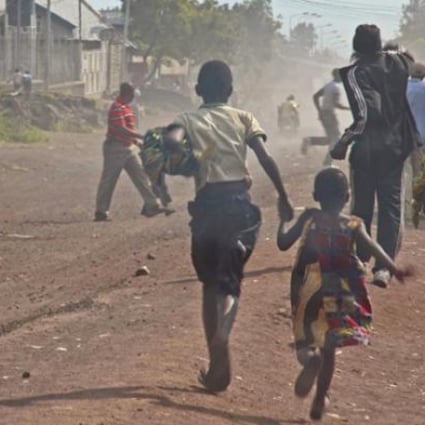 People flee as fighting erupts between the M23 rebels and Congolese army near the airport at Goma on Monday. Photo: AP