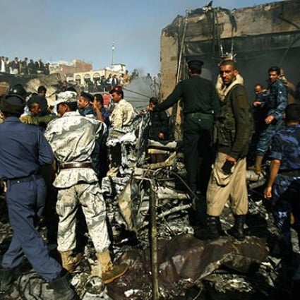Rescuers work at the scene of a plane crash in Sanaa on Wenesday. Photo: AP
