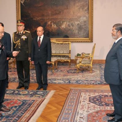 Egyptian President Mohammed Mursi (right) swearing in new Prosecutor-General Talaat Ibrahim (left) at the presidential palace in Cairo on Thursday. Photo: AFP