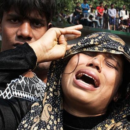 A woman cries over loss of her husband after a fire in a garment factory near Dhaka. Photo: Xinhua