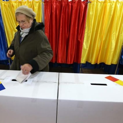 A Romanian woman casts her ballot at a polling station in Bucharest, Romania. Photo: EPA
