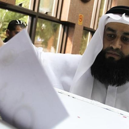 An Egyptian man, living in UAE, casts his vote during the referendum for the Egyptian new constitution, at the Egyptian consulate in Dubai, UAE on Wednesday. Photo: EPA