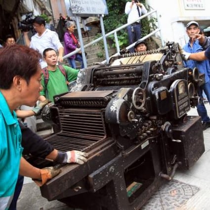 The Original Heidelberg Cylinder Letter Press Machine is moved from the closing Wai Che Printing Company yesterday. Photo: Jonathan Wong