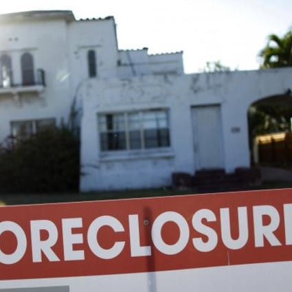 A foreclosure sale sign sits in front of a house in Miami Beach, Florida in this file photo taken February 27, 2009. Photo: Reuters