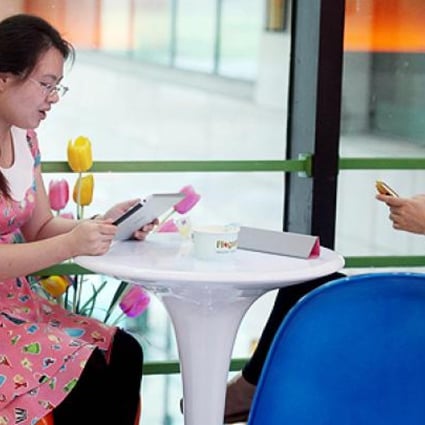 Women use the internet in a restaurant in Haikou, China. Photo: AFP