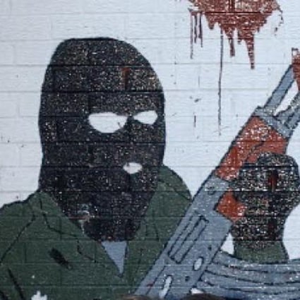 An IRA mural in Belfast recalls Northern Ireland's troubled sectarian past. Two men were in custody on Tuesday after the attempted murder of a police officer in the province. A group calling itself the "New IRA" has claimed responsibility. Photo: AP