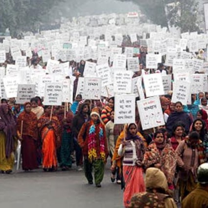 Hundreds of Indian women and men participate in peace march with placards carrying pro-women slogans in New Delhi. Photo: EPA