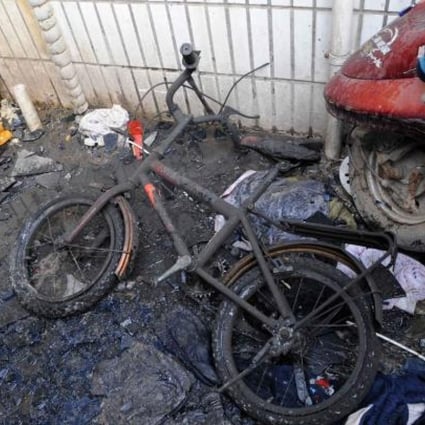 A damaged bicycle at the scene of the fire. Photo: Xinhua