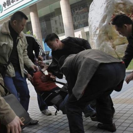 Plainclothes police take away a protester from near the office of Southern Weekly. Photo: Reuters