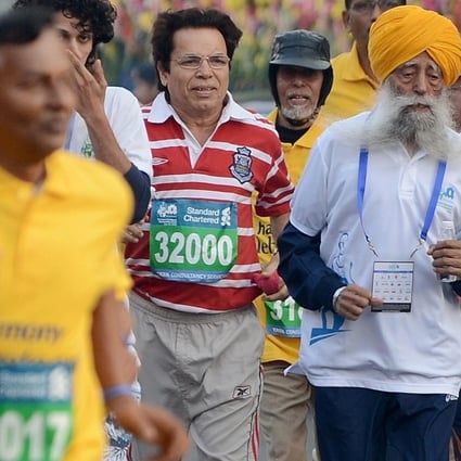 Sikh marathon runner Fauja Singh, 101, shows he is still going strong in the Mumbai Marathon on Sunday. Photo: AFP