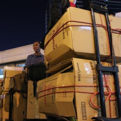 Parallel traders carry goods across the border at Sheung Shui, where police and customs officers swooped this week. Photo: Felix Wong