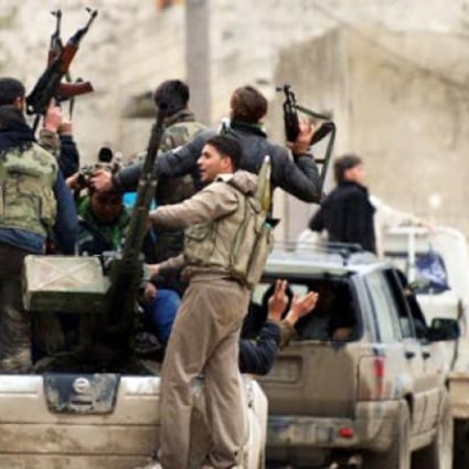 Syrian rebel fighters in action at the village of Aljanodiy. Photo: AFP