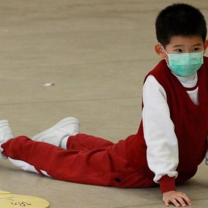 A local student wears a mask as he attends a PE lesson on a hazy day. Photo: K. Y. Cheng