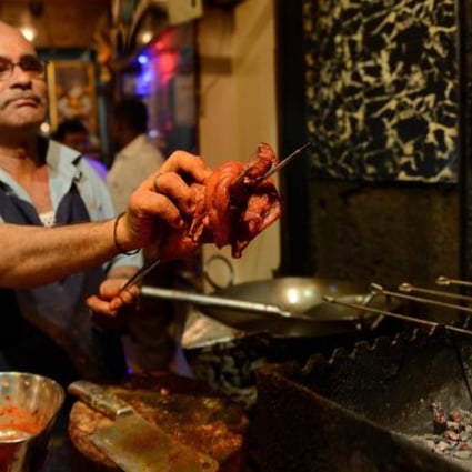 A chef prepares to grill a chicken at a Mumbai restaurant. India’s growing wealth has increased demand for meat, particularly from the newly affluent middle class. Photo: AFP