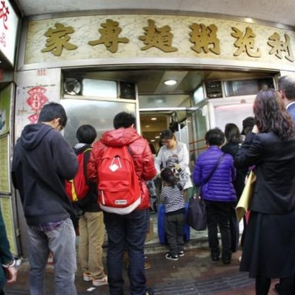 People queue outside Lei Yuen, a 40-year-old noodle and congee shop in Causeway Bay which has closed because of soaring rent. Photo: May Tse