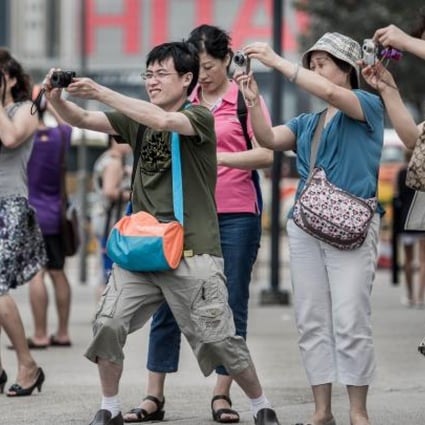 Tourists from mainland China take pictures during a visit to Hong Kong. Photo: AFP