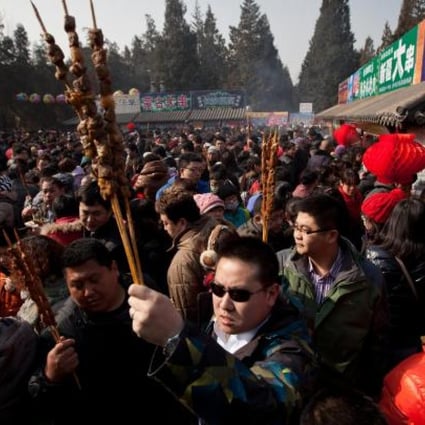 Beijingers relish mutton kebabs at Lunar New Year. Photo: AP