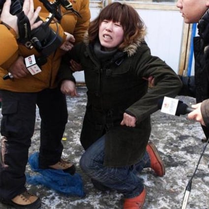 An aunt of the abducted infant Xu Haobo reacts after learning of his abduction. Photo: China Foto Press