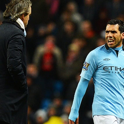 Carlos Tevez (right) and Manchester City manager Roberto Mancini. Photo: AFP