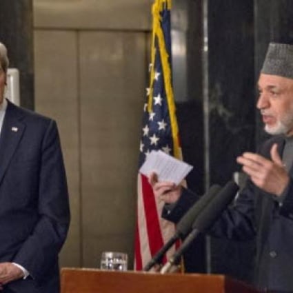 US Secretary of State John Kerry listens as Afghan President Hamid Karzai speaks during their joint news conference at the presidential palace in Kabul. Ph 