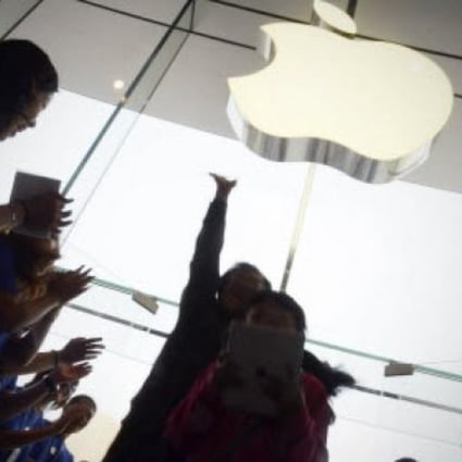 Apple staff welcome customers in an Apple store at WangFujin business district in Beijing. Photo: AFP