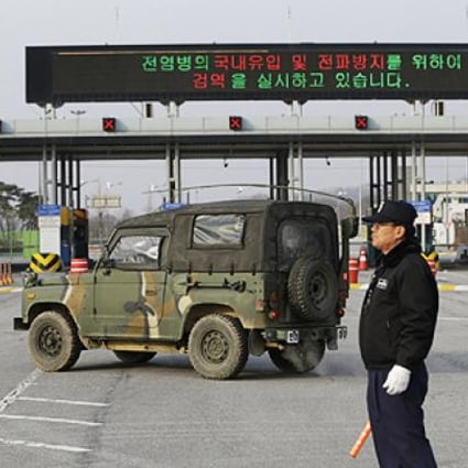 A South Korean military vehicle passes by gates leading to the North Korean city of Kaesong. Photo: AP