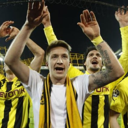 Borussia Dortmund's Marco Reus (C) and team mates celebrate after defeating Malaga to win the Champions League quarter-final second leg soccer match, in the western German city of Dortmund. Photo: Reuters.