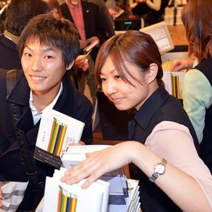 Fans of Japanese author Haruki Murakami buy his newly published book at the Tsutaya book store in Tokyo. Photo: AFP