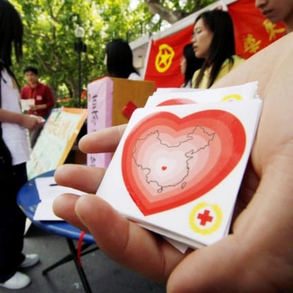 Students distribute Red Cross stickers in Shanghai. Photo: AP