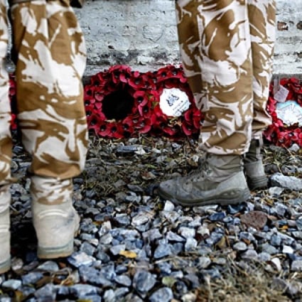 British soldiers attend a Remembrance Day ceremony at the British cemetery in Kabul. Photo: Reuters