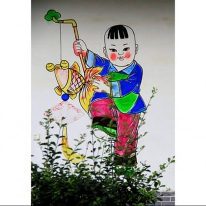 A painting decorates one of the new houses in Jiulong.