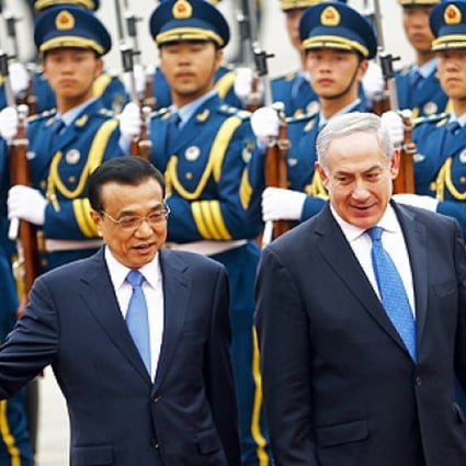 Chinese Premier Li Keqiang (left) walks with visiting Israeli Prime Minister Benjamin Netanyahu during a welcoming ceremony at the Great Hall of the People in Beijing, on Wednesday. Photo: EPA