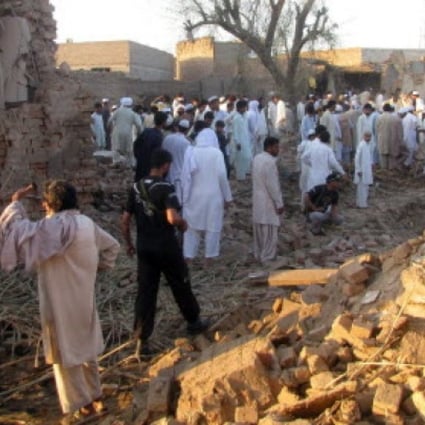 Pakistani security officials inspect the damage caused by a suicide bomb attack that targeted a police station in Bannu on Wednesday. Photo: AFP