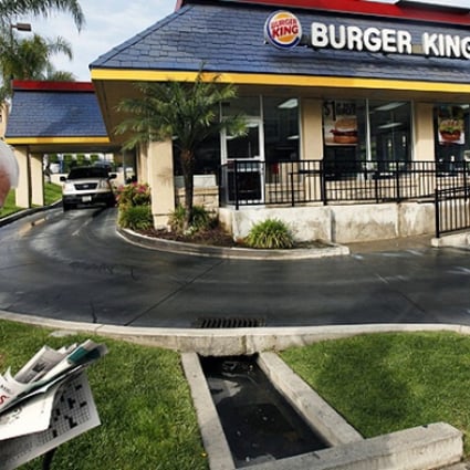 A pedestrian walks past a Burger King restaurant near downtown Los Angeles. Photo: AP