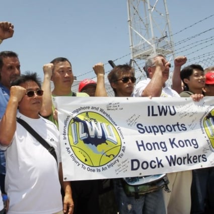 Unionists including Stanley Ho (left) cheer dockers on their first day back at the port. Photo: Edward Wong