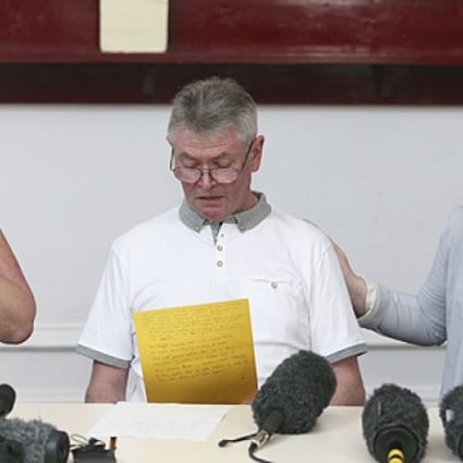 Murdered British soldier Lee Rigby's stepfather Ian, seated between his mother Lyn (left) and his wife Rebecca Rigby, reads a statement during a press conference at the Regimental HQ of his unit, the Royal Regiment of Fusiliers at Bury in Greater Manchester, England, on Friday. Photo: AP