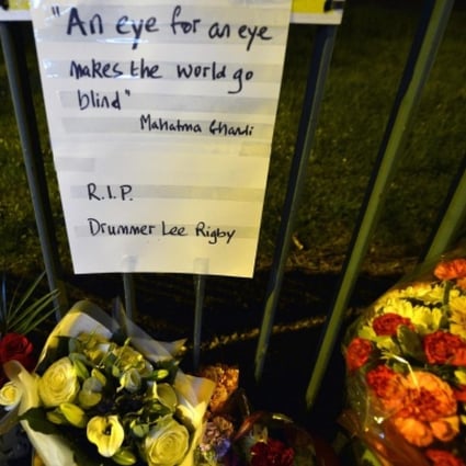 Flowers at the barracks with a message in memory of Lee Rigby - one of his killers said it was an "eye for an eye". Photo: Reuters