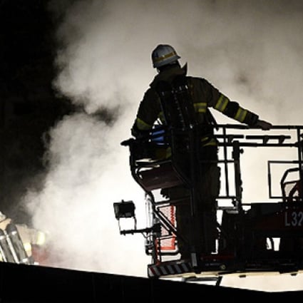 Firemen extinguish a blaze at a nursery school in the suburb of Kista after youths rioted in several different suburbs around Stockholm, Sweden on Thursday. Photo: AFP