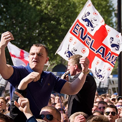 A supporter of the far-right English Defence League (EDL) gestures near Downing Street during a protest. Photo: AFP